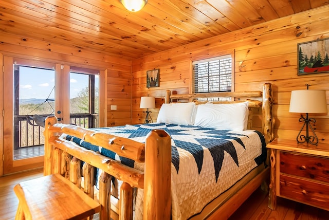 bedroom with access to outside, hardwood / wood-style flooring, and wood ceiling