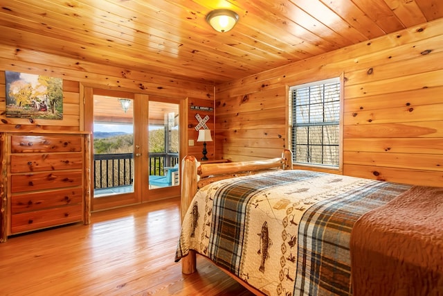 bedroom with wood ceiling, light wood-type flooring, and access to outside