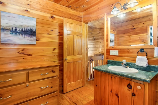 bathroom featuring hardwood / wood-style floors, vanity, and wooden ceiling