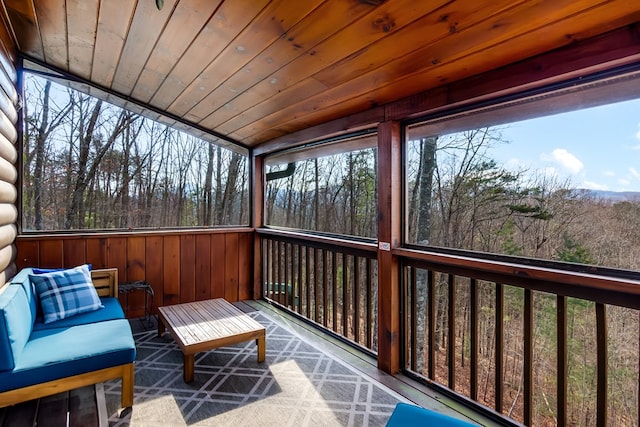 sunroom / solarium featuring a wealth of natural light and wood ceiling