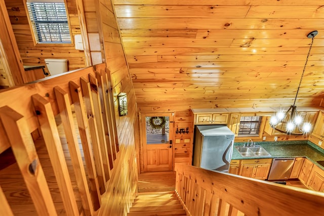 corridor featuring wooden walls, sink, light hardwood / wood-style floors, and a notable chandelier