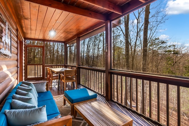 sunroom featuring beam ceiling and wood ceiling