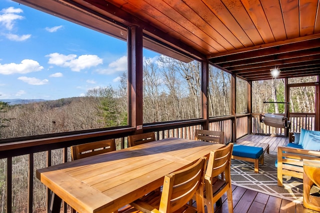 sunroom with a wealth of natural light and wood ceiling