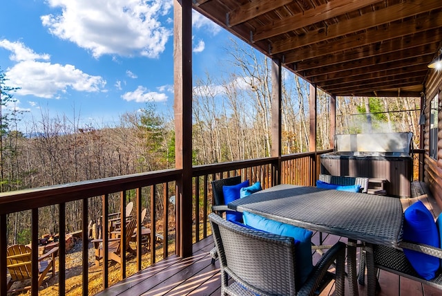 wooden terrace featuring area for grilling and a hot tub