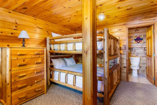 bedroom featuring wood ceiling and connected bathroom