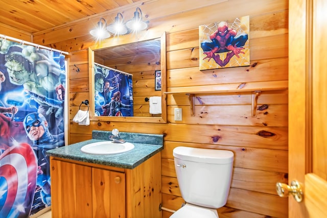 bathroom with vanity, wood walls, toilet, and wooden ceiling