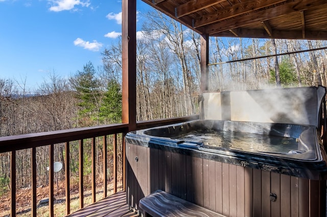 wooden terrace featuring a hot tub