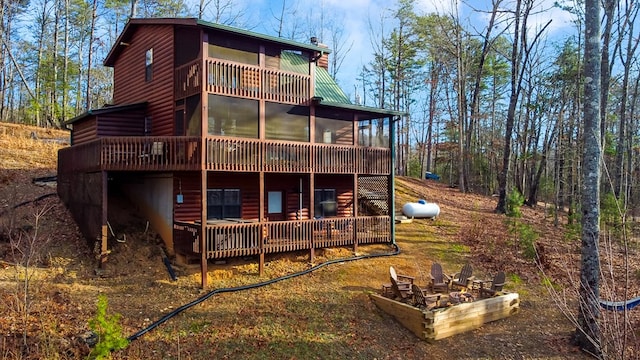 rear view of property with a sunroom