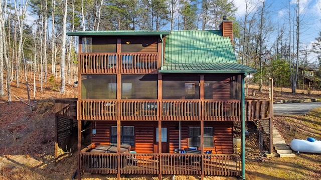 view of front facade with a sunroom and a deck