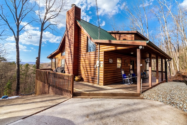 view of side of home featuring a porch and a deck