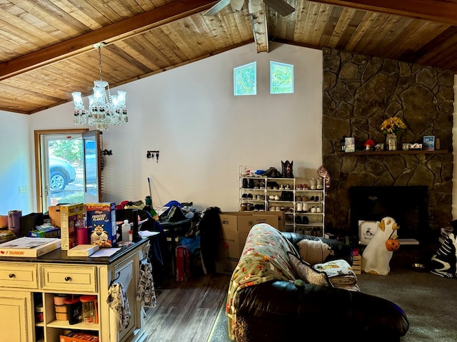 living room featuring a fireplace, a chandelier, dark hardwood / wood-style flooring, and vaulted ceiling with beams