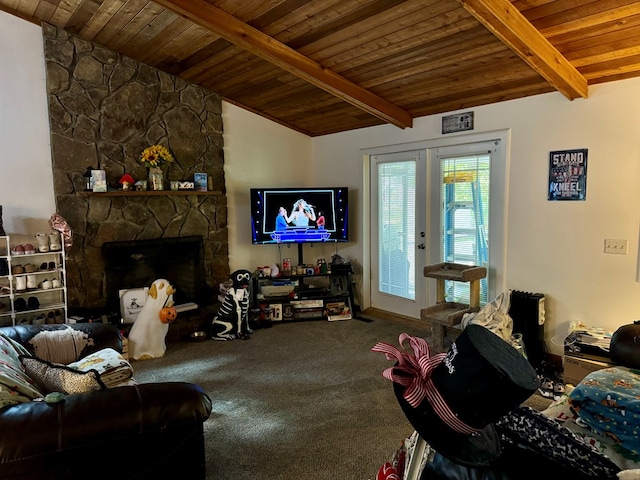 living room featuring carpet flooring, lofted ceiling with beams, and a stone fireplace