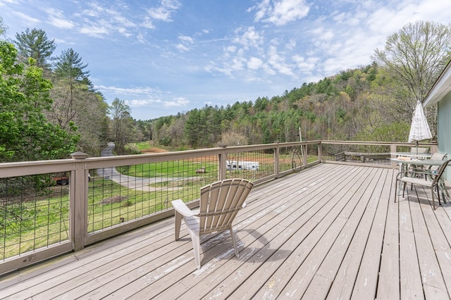 wooden deck featuring a forest view