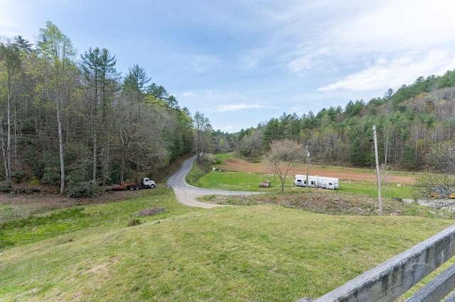 view of road featuring a forest view