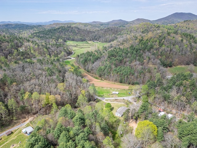 aerial view with a mountain view and a wooded view