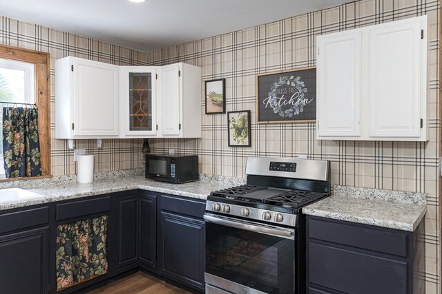 1244 Cook Creek Rd, Murphy, NC 28906 - kitchen with black microwave, gas stove, white cabinetry, dark wood-type flooring, and glass insert cabinets