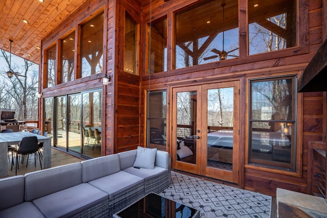 sunroom with french doors, ceiling fan, and wooden ceiling