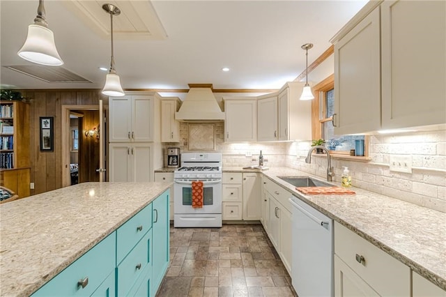 kitchen with white appliances, a sink, hanging light fixtures, and custom exhaust hood