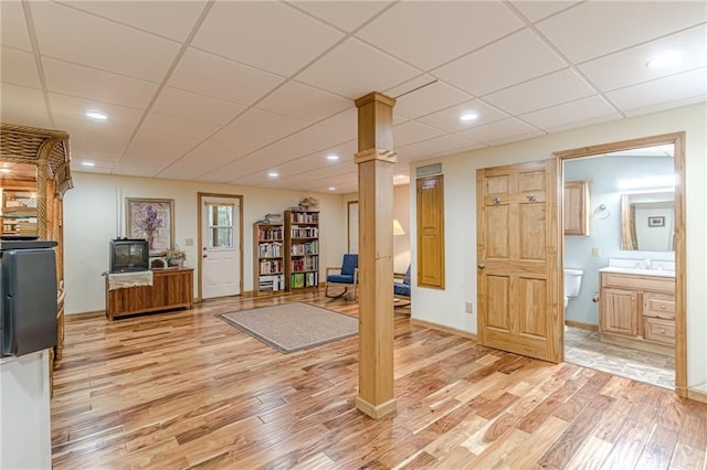 workout room with light wood-type flooring, a sink, a paneled ceiling, and recessed lighting