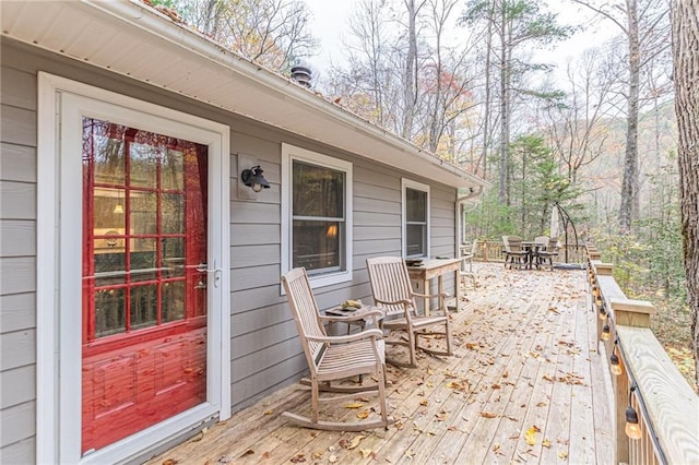 deck with outdoor dining area