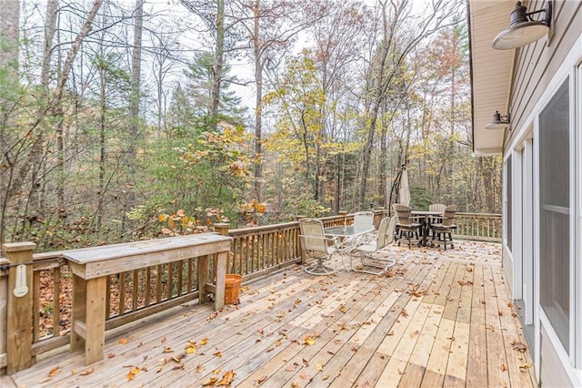 wooden terrace featuring outdoor dining area