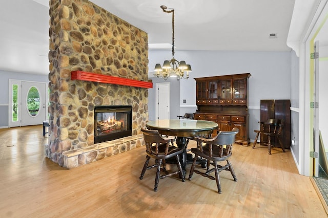 59 Tusquittee Creek Ln, Hayesville, NC 28904 - dining room with a chandelier, light wood finished floors, and a fireplace
