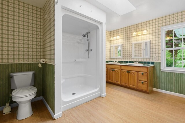 59 Tusquittee Creek Ln, Hayesville, NC 28904 - bathroom with wallpapered walls, a skylight, a shower stall, wood finished floors, and toilet