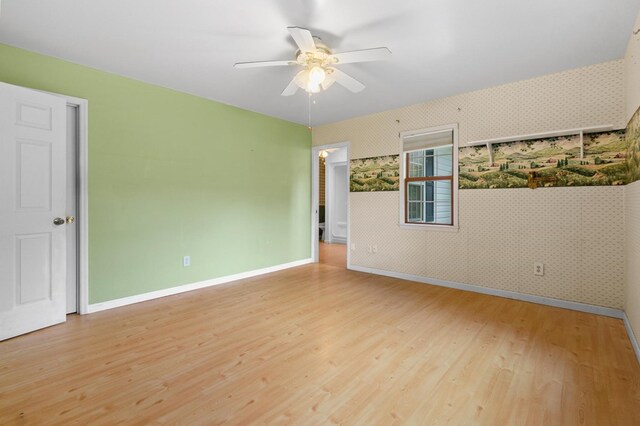 59 Tusquittee Creek Ln, Hayesville, NC 28904 - spare room featuring wallpapered walls, wood finished floors, ceiling fan, and baseboards