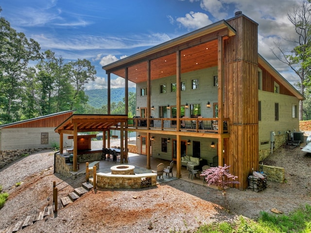 558 Tipton Springs Rd, Morganton, GA 30560 - rear view of house with a patio, central AC unit, a mountain view, and an outdoor living space with a fire pit