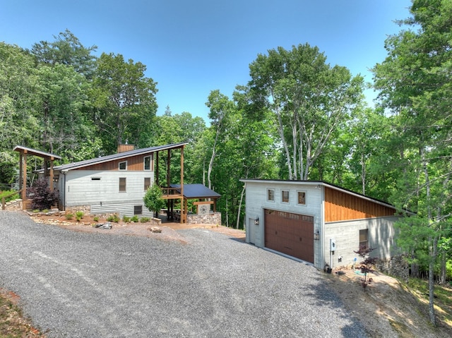 558 Tipton Springs Rd, Morganton, GA 30560 - view of front of house featuring a garage, a chimney, an outbuilding, and view of scattered trees