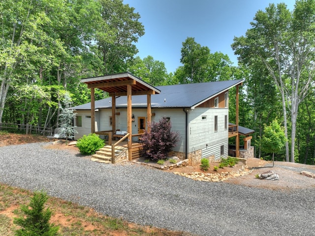 558 Tipton Springs Rd, Morganton, GA 30560 - view of front facade with metal roof, a deck, view of wooded area, and driveway