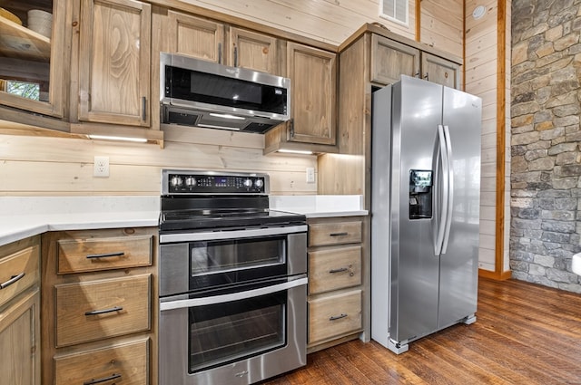 558 Tipton Springs Rd, Morganton, GA 30560 - kitchen featuring stainless steel appliances, wood walls, light countertops, dark wood-type flooring, and brown cabinetry