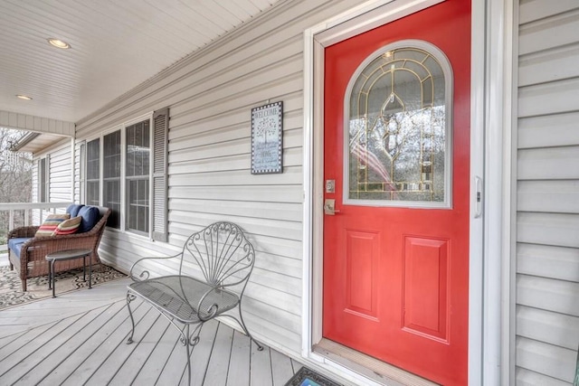 view of exterior entry featuring covered porch