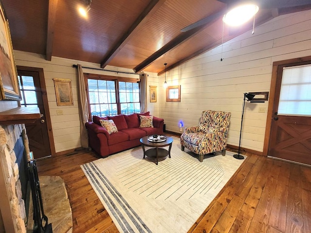 living room featuring dark hardwood / wood-style flooring, wood ceiling, ceiling fan, wooden walls, and vaulted ceiling with beams