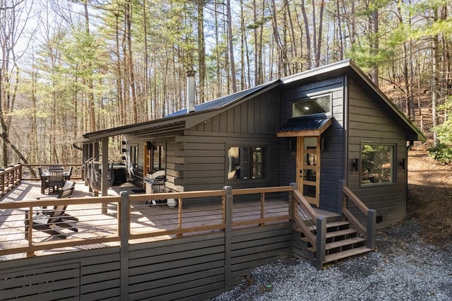 view of property exterior featuring a wooden deck