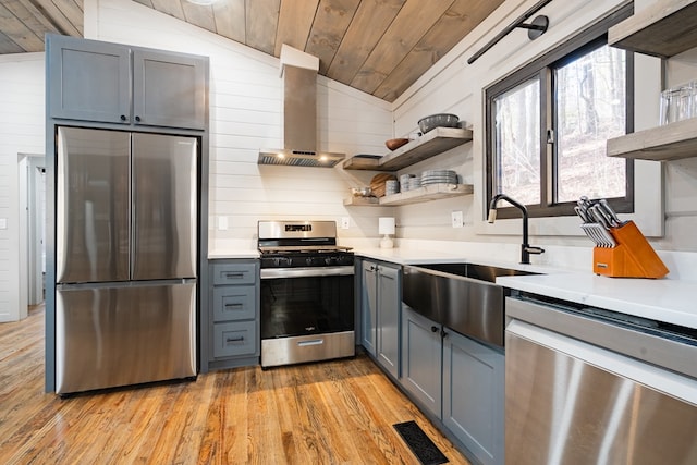 kitchen with stainless steel appliances, light wood-type flooring, exhaust hood, vaulted ceiling, and wooden ceiling