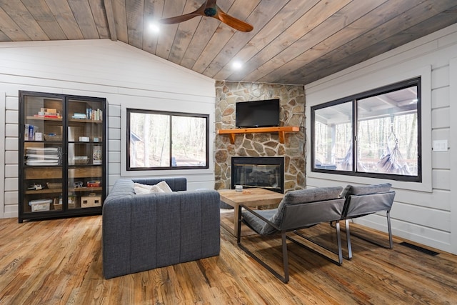 living room with wood ceiling, wood-type flooring, lofted ceiling, and a fireplace