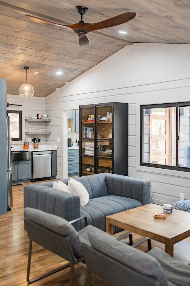 living room featuring wooden walls, wood ceiling, vaulted ceiling, and light hardwood / wood-style floors