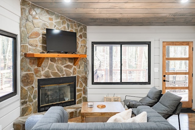 living room featuring a fireplace, a wealth of natural light, wood-type flooring, and wood ceiling