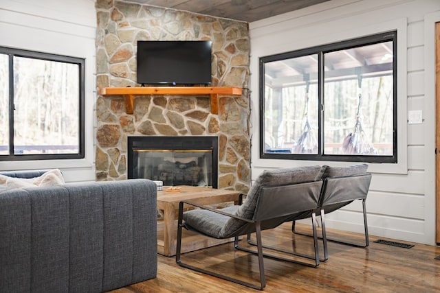 living room with wood ceiling, wood-type flooring, and a fireplace