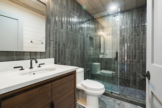 bathroom with a shower with door, vanity, and toilet