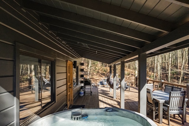 view of patio with a deck and a hot tub