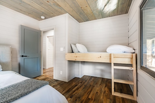 bedroom featuring wooden ceiling, dark hardwood / wood-style floors, and wooden walls