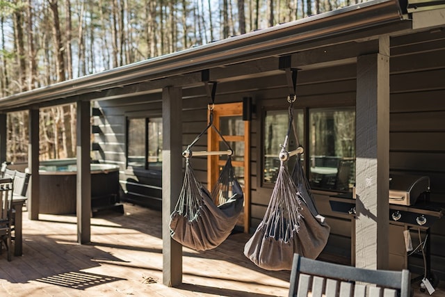 view of patio featuring a hot tub and a wooden deck