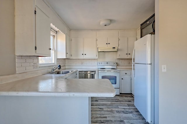 kitchen featuring backsplash, kitchen peninsula, white cabinetry, and white appliances