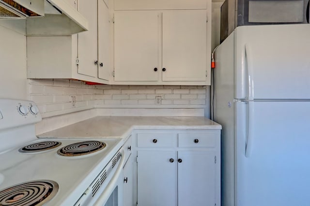 kitchen featuring white cabinets, white appliances, and tasteful backsplash