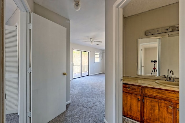 bathroom with ceiling fan and vanity