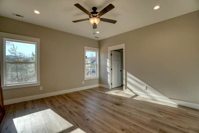 empty room featuring hardwood / wood-style floors and ceiling fan