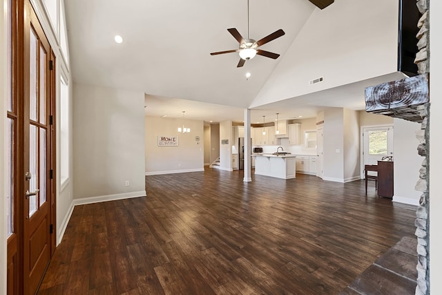 unfurnished living room with visible vents, dark wood-type flooring, ceiling fan, and a sink