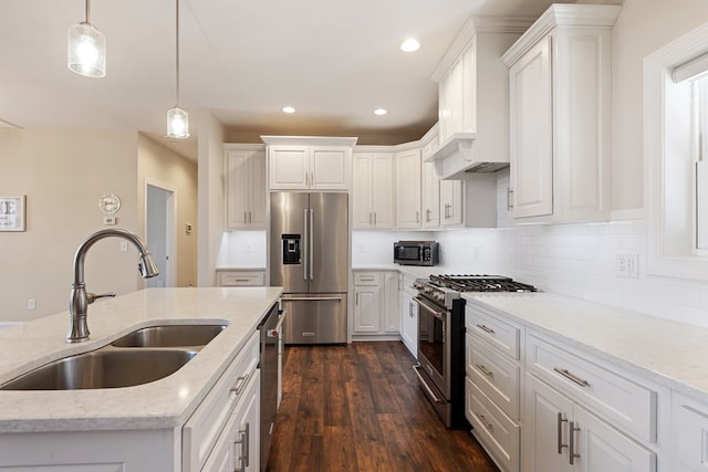 kitchen with white cabinetry, dark wood-type flooring, high quality appliances, and a sink